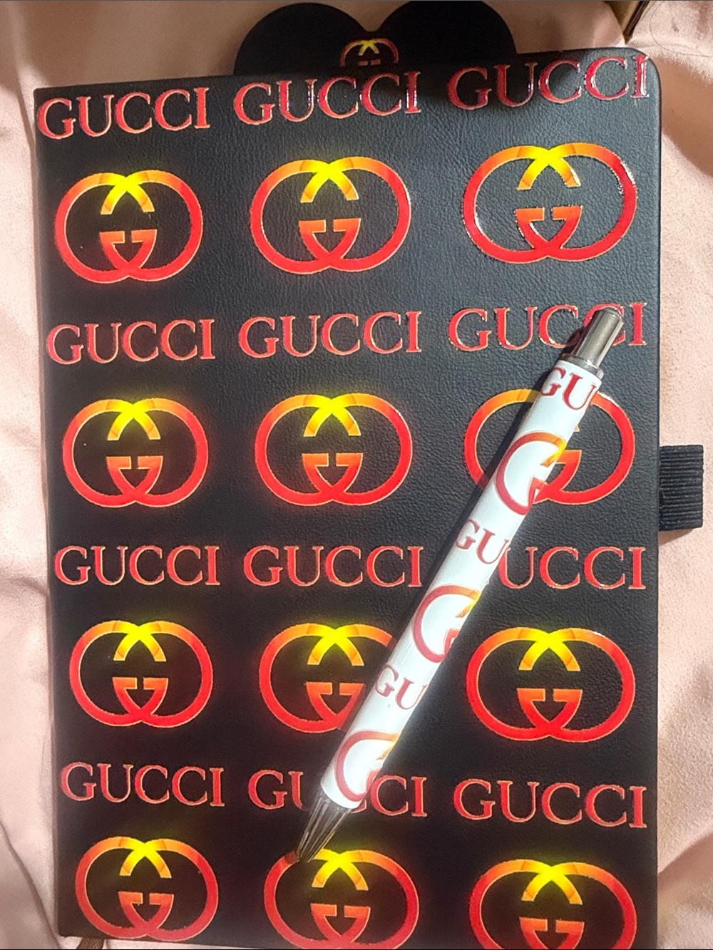 Black journal with Red and Gold Logo Pattern with matching pen & bookmark.